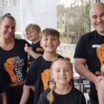 Jon Sharkey with his wife and children wearing fighter jet shirts in support of Jett’s leukemia battle